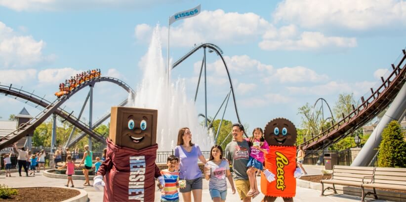 Family and Hershey Characters in front of Kisses fountain
