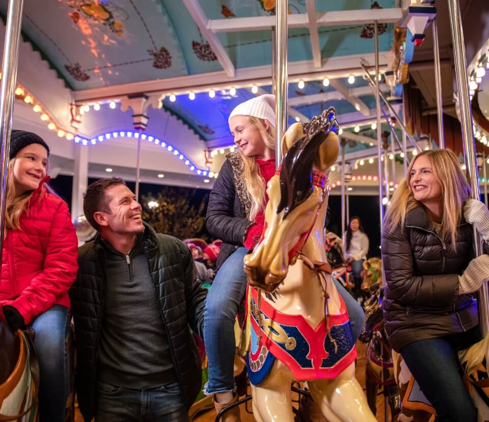 Family riding carrousel at Hersheypark Christmas Candylane