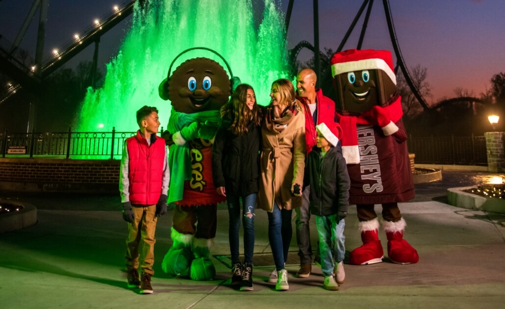 Christmas Characters at family at Hersheypark in front of Kisses fountain